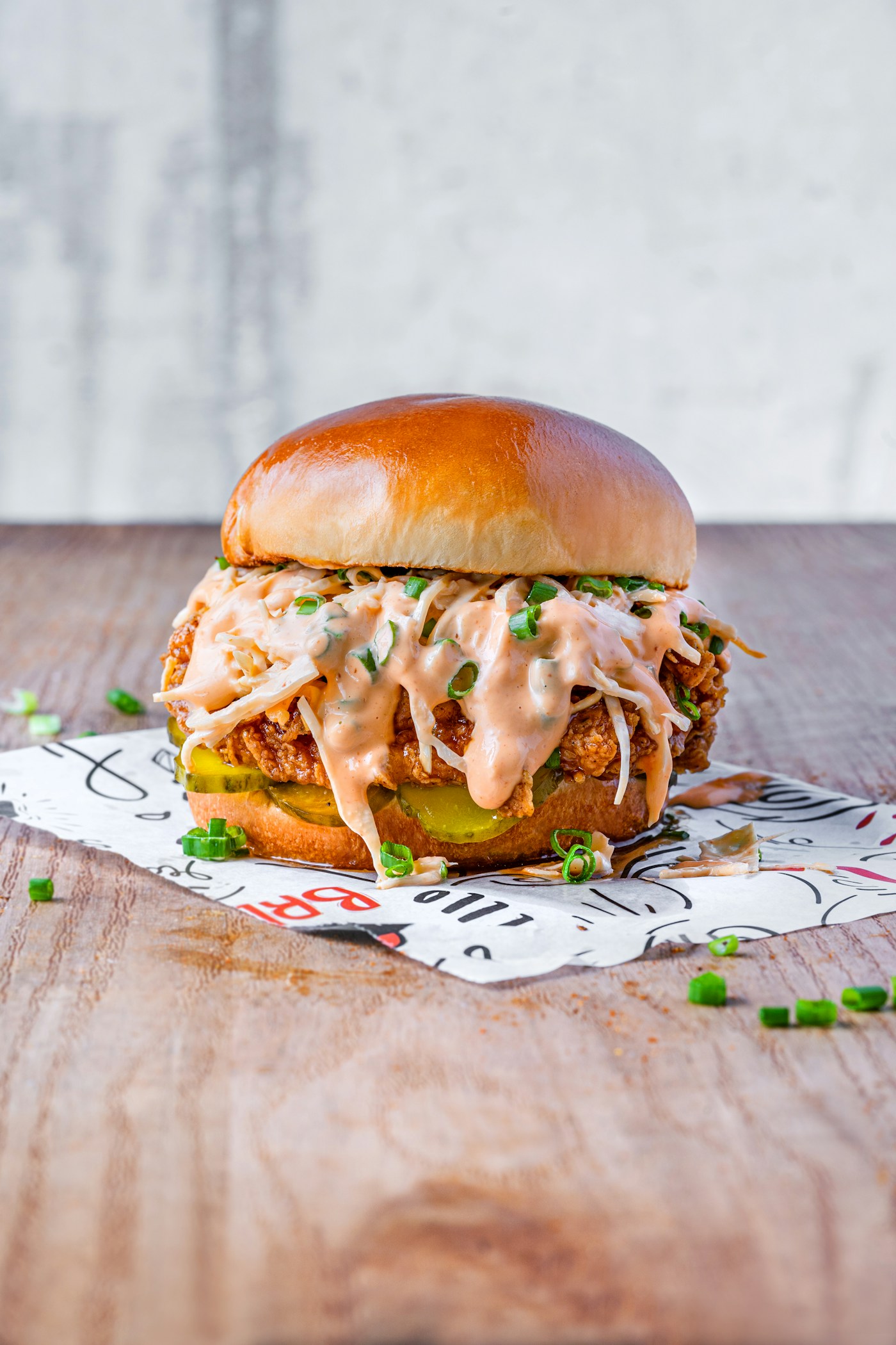 Crispy chicken burger with slaw and sauce