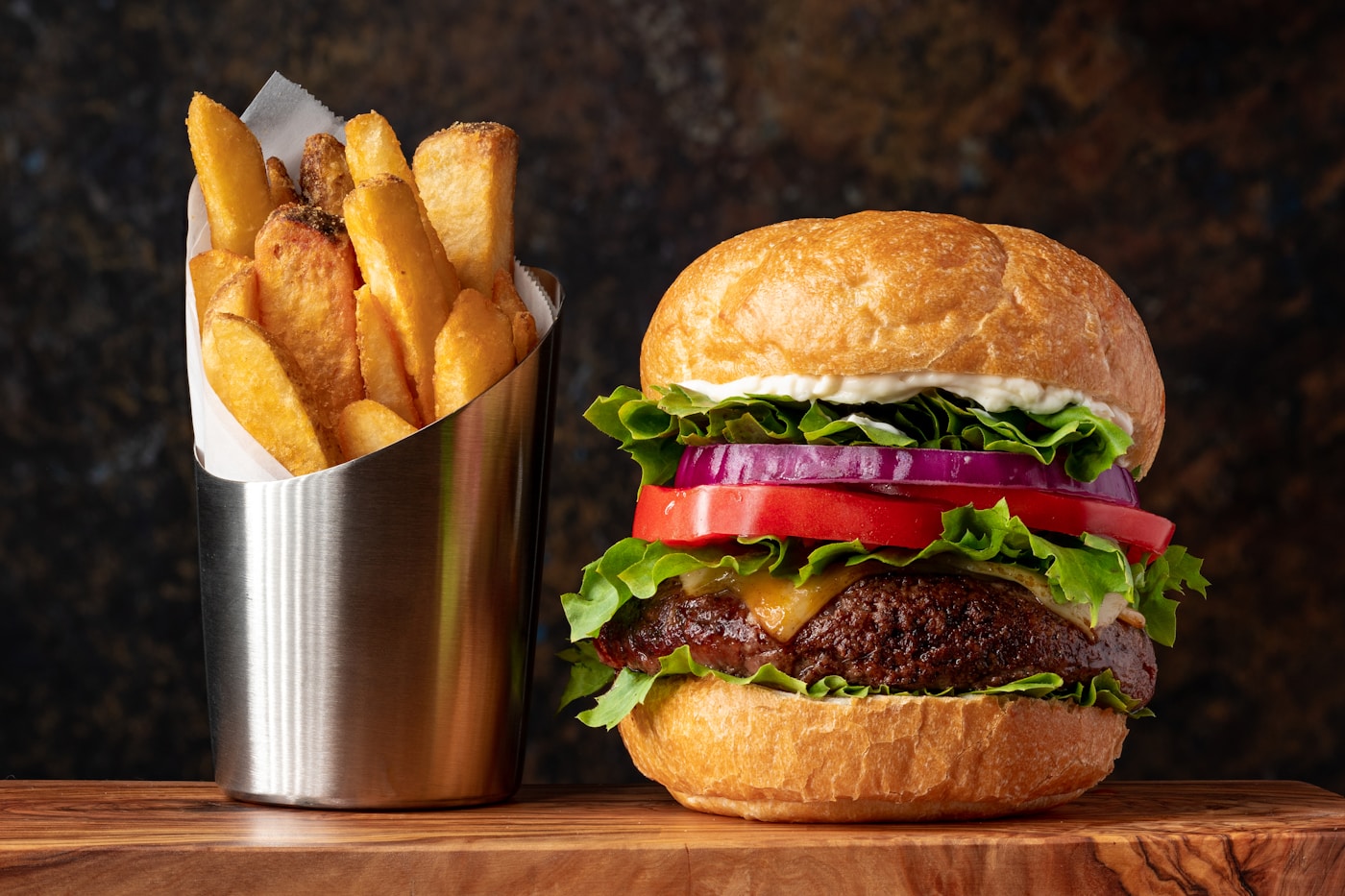 Tall beef burger stack with cheese and sauce